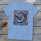 Light blue t-shirt with a vintage banjo design and text that reads Old Sounds New Ground.