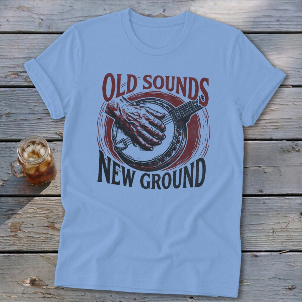 Light blue t-shirt with a vintage banjo design and text that reads Old Sounds New Ground.
