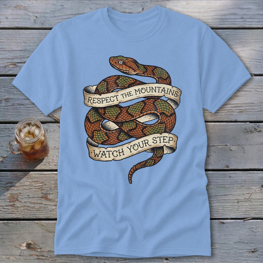 Light blue t-shirt featuring a coiled snake with banners reading "Respect the Mountains" and "Watch Your Step".