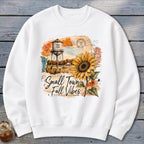 White sweatshirt with sunflower, water tower, and "Small Town Fall Vibes" text.