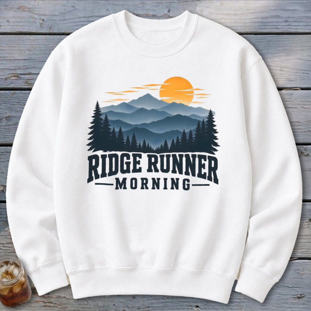 White sweatshirt with "Ridge Runner Morning" text and mountain sunset graphic.
