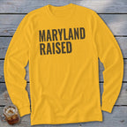 Yellow long-sleeve shirt with "MARYLAND RAISED" text in dark gray.