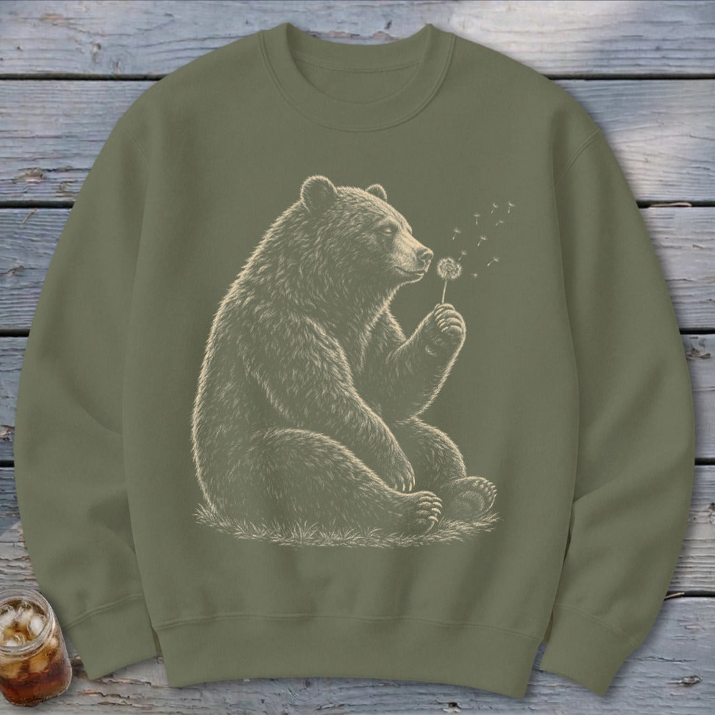 Olive green sweatshirt with bear blowing dandelion seeds graphic.
