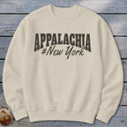 Cream sweatshirt with "APPALACHIA #New York" graphic in dark gray.