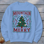 A light blue crewneck sweatshirt featuring a graphic of a Christmas tree with text reading Mountain Merry.