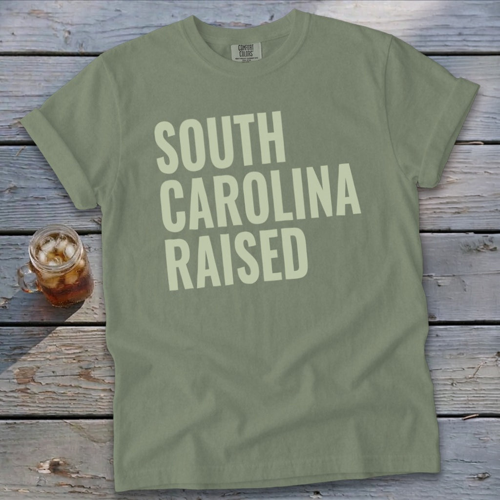 Green Comfort Colors t-shirt with "SOUTH CAROLINA RAISED" text and glass of iced tea.