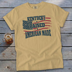 T-shirt with "Kentucky Raised American Made" text and American flag graphic.