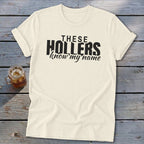 Cream t-shirt with black text that says "THESE HOLLERS know my name".