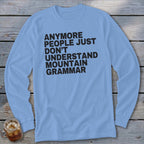Light blue long sleeve shirt with black text reading "ANYMORE PEOPLE JUST DON'T UNDERSTAND MOUNTAIN GRAMMAR".
