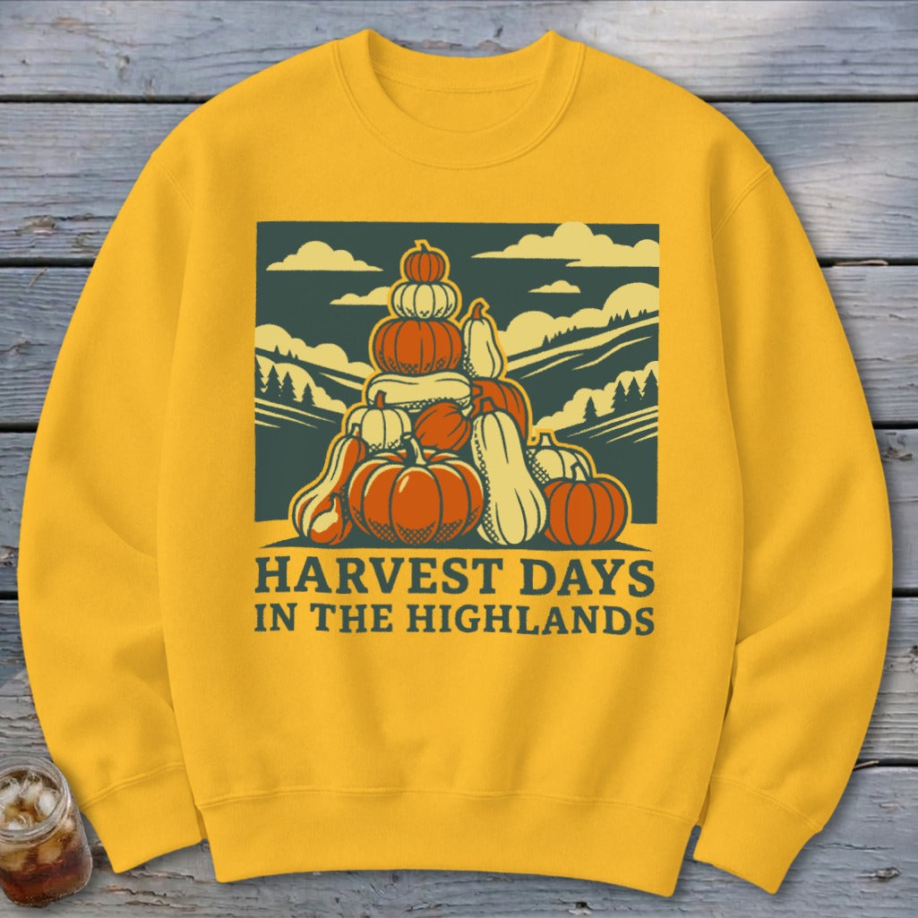 Golden yellow sweatshirt with a retro graphic of a pumpkin stack and Harvest Days in the Highlands text.