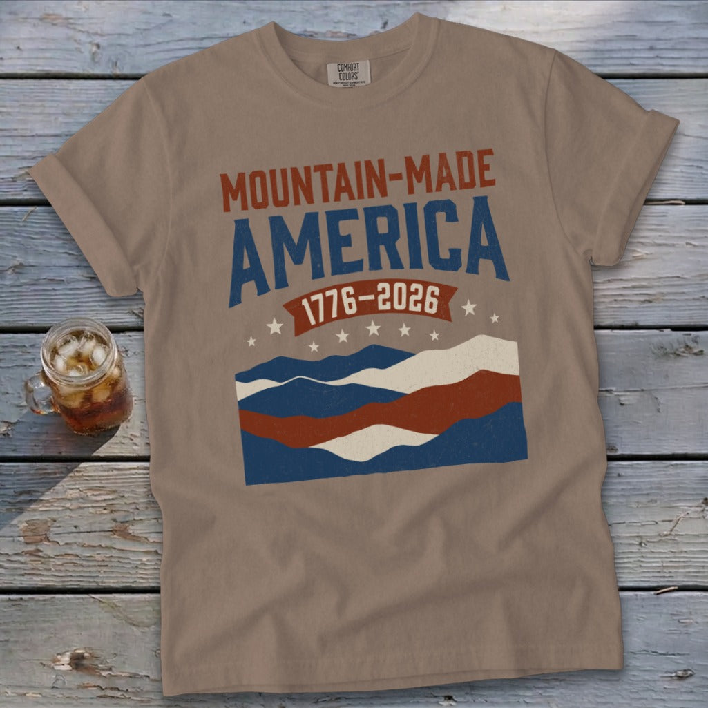 Brown t-shirt with "Mountain-Made America 1776-2026" and mountain graphic.