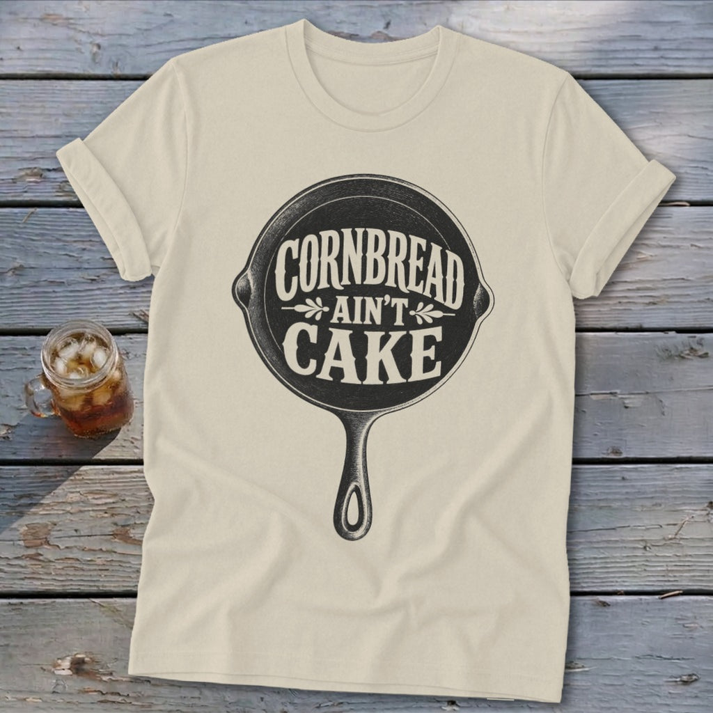 Cream t-shirt with cast iron skillet graphic and text "Cornbread Ain't Cake".