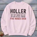 Light pink sweatshirt with text: "HOLLER NOT JUST WHERE YOU LIVE BUT HOW YOU CALL SOMEONE FIVE RIDGES OVER".