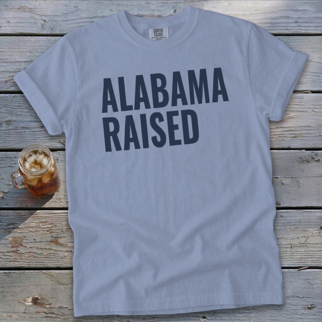 Light blue t-shirt with dark blue text "ALABAMA RAISED" and a mason jar with iced tea.