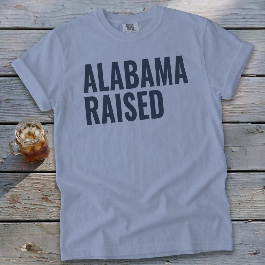 Light blue t-shirt with dark blue text "ALABAMA RAISED" and a mason jar with iced tea.