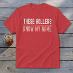 Red t-shirt with "THESE HOLLERS KNOW MY NAME" text in white and tan.
