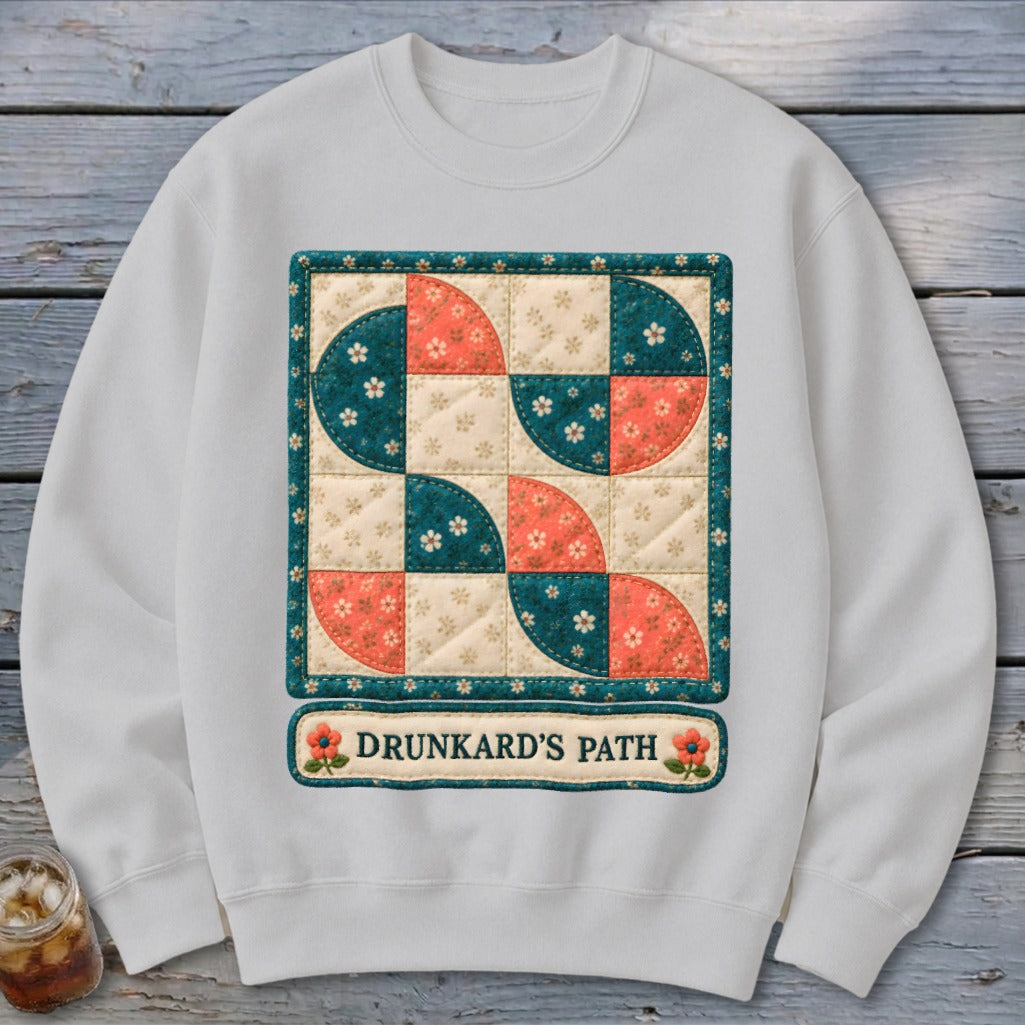 White sweatshirt with a quilt square design and "Drunkard's Path" text.
