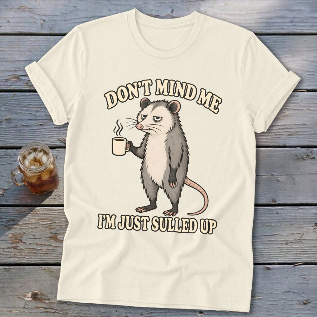 Opossum holding a mug with text "Don't mind me I'm just sulled up."