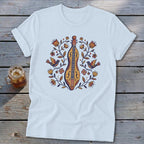 White t-shirt with folk art of a fiddle, birds, and flowers design.
