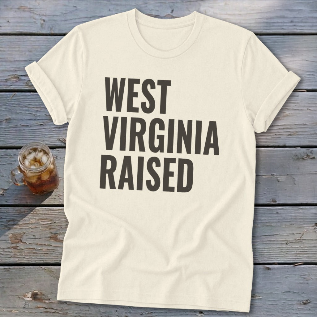 Cream t-shirt with "WEST VIRGINIA RAISED" printed in dark grey block letters.