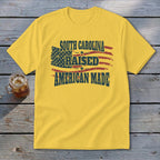 Yellow t-shirt with American flag graphic and "South Carolina Raised American Made" text.