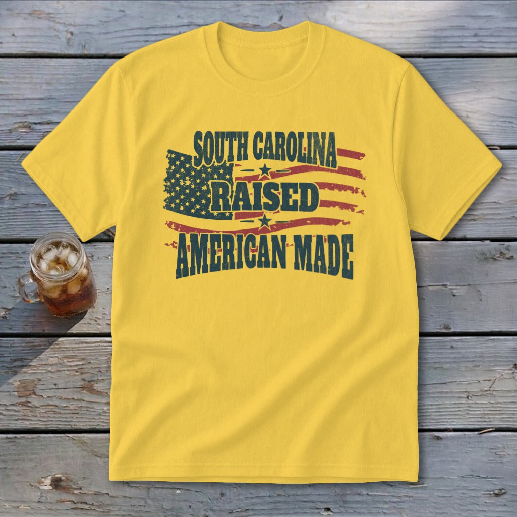 Yellow t-shirt with American flag graphic and "South Carolina Raised American Made" text.