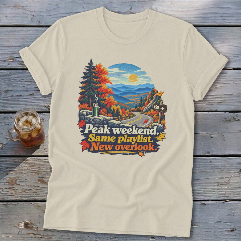 T-shirt graphic: Peak weekend. Same playlist. New overlook. Autumn mountain road.