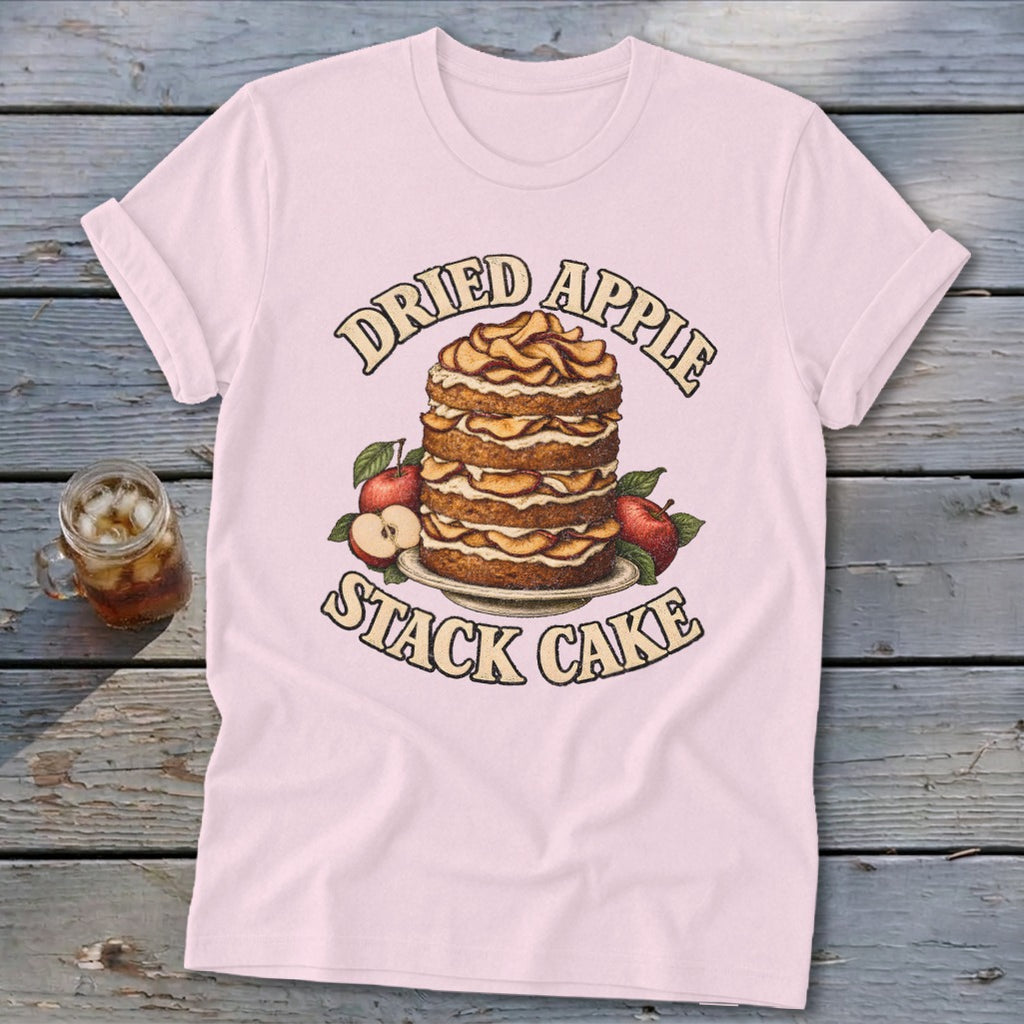 Pink t-shirt with a graphic of a dried apple stack cake and apples.