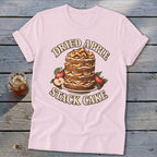 Pink t-shirt with a graphic of a dried apple stack cake and apples.