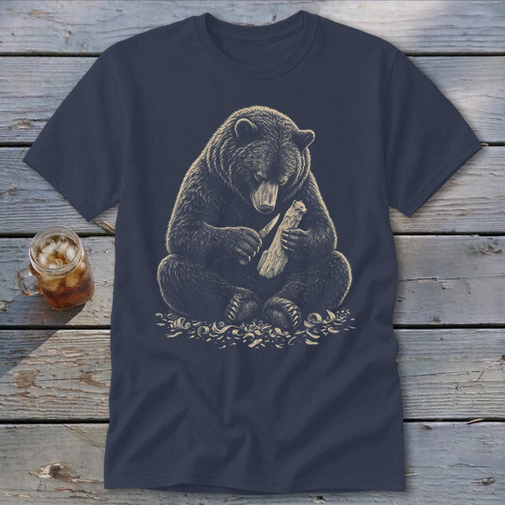 Bear carving wood with a knife on a navy t-shirt.