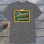 Charcoal gray crewneck t-shirt featuring a green vintage-style marquee sign graphic that reads "Dinner on the Grounds".