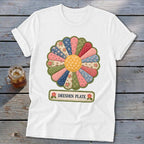 White t-shirt with a colorful Dresden Plate quilt design and text.