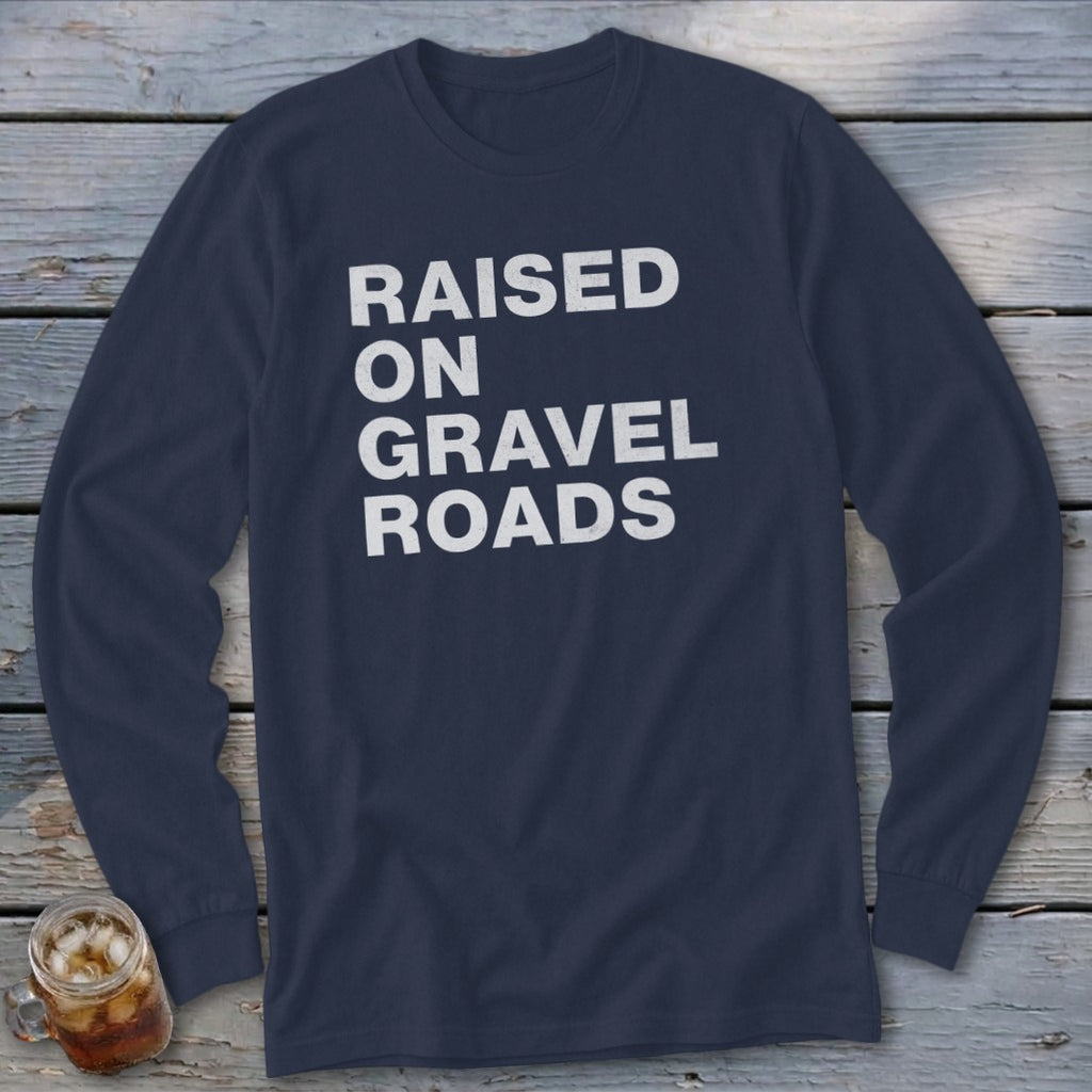 Navy long sleeve shirt with "RAISED ON GRAVEL ROADS" in white text.