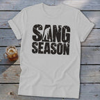 Light gray t-shirt featuring distressed black text that reads SANG SEASON with a silhouette of a person digging.