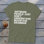 Olive green t-shirt with white text: "Anymore people just don't understand mountain grammar."