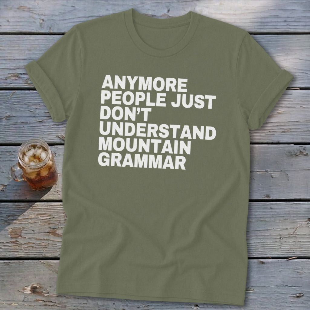 Olive green t-shirt with white text: "Anymore people just don't understand mountain grammar."