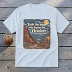 Light blue t-shirt with graphic "Took the long way home for October" and autumn mountain scene.