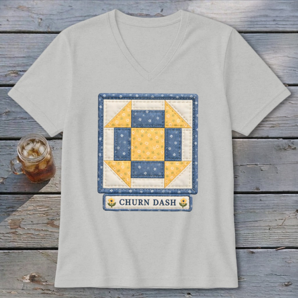 T-shirt with a "Churn Dash" quilt block design in blue and yellow.