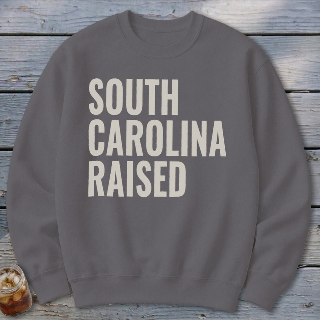 Gray sweatshirt with "SOUTH CAROLINA RAISED" text in off-white block letters.