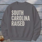 Gray sweatshirt with "SOUTH CAROLINA RAISED" text in off-white block letters.