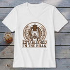 White v-neck t-shirt with brown lantern emblem and "Established In The Hills" text.
