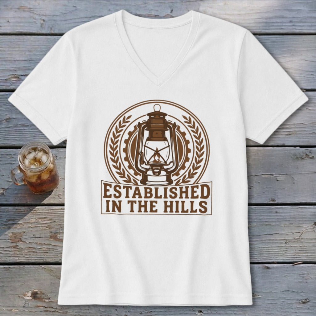 White v-neck t-shirt with brown lantern emblem and "Established In The Hills" text.