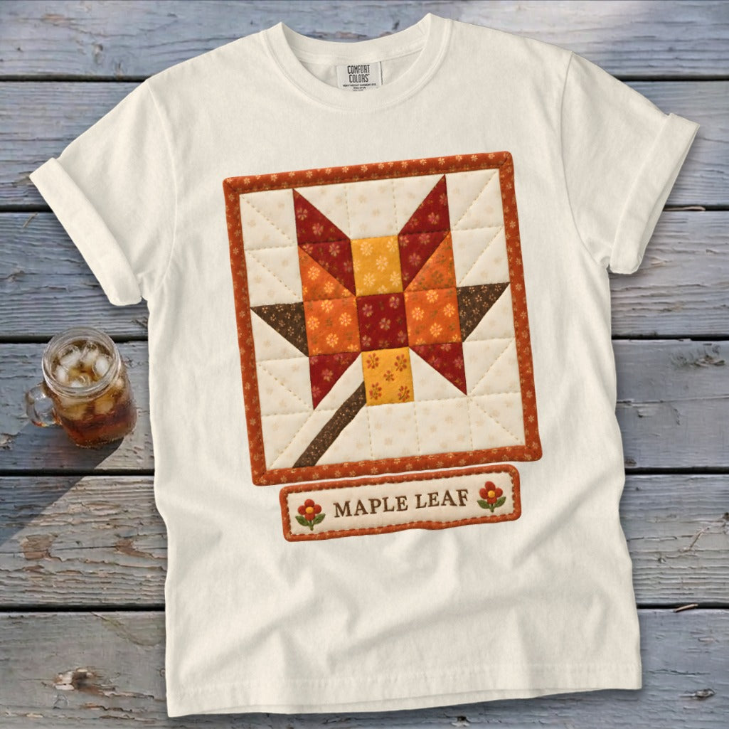 Cream t-shirt with a quilted maple leaf design and "Maple Leaf" text label.