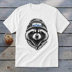 White t-shirt with a black and white illustration of a raccoon wearing a beanie with mountains.