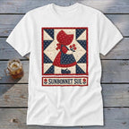 White t-shirt featuring a quilt block design of Sunbonnet Sue holding flowers, with text "SUNBONNET SUE".