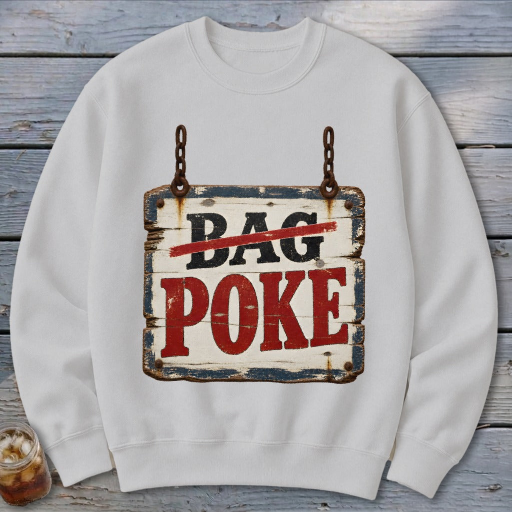 A white crewneck sweatshirt featuring a graphic of a rustic, weathered wooden sign with the text BAG POKE.