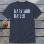 Navy t-shirt with "MARYLAND RAISED" in light blue text.