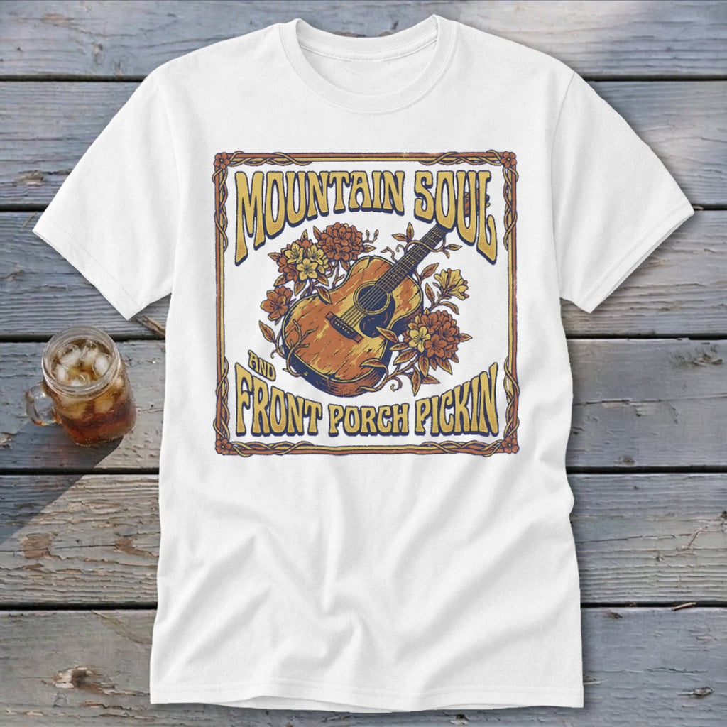 White t-shirt with "Mountain Soul and Front Porch Pickin" text and acoustic guitar graphic.
