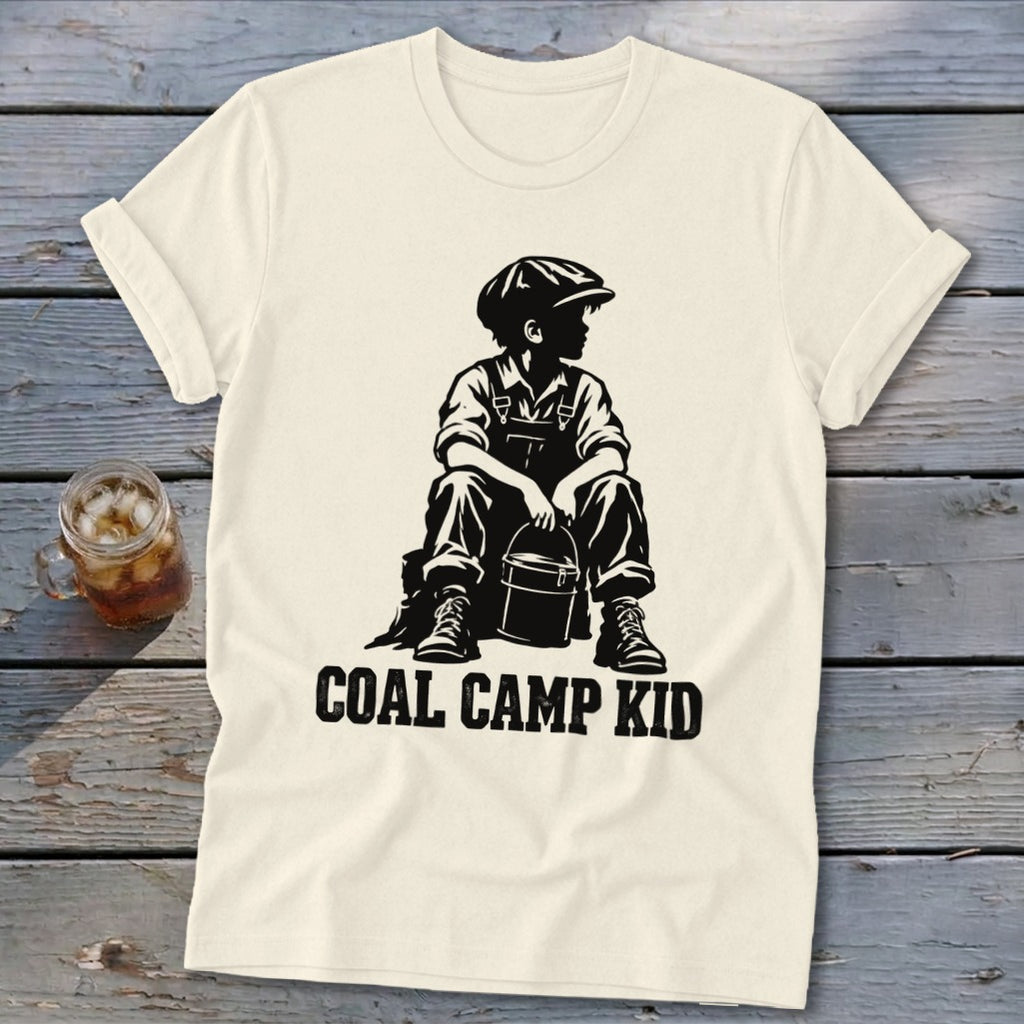 Cream t-shirt with black graphic of a boy sitting and holding a bucket, text "COAL CAMP KID".