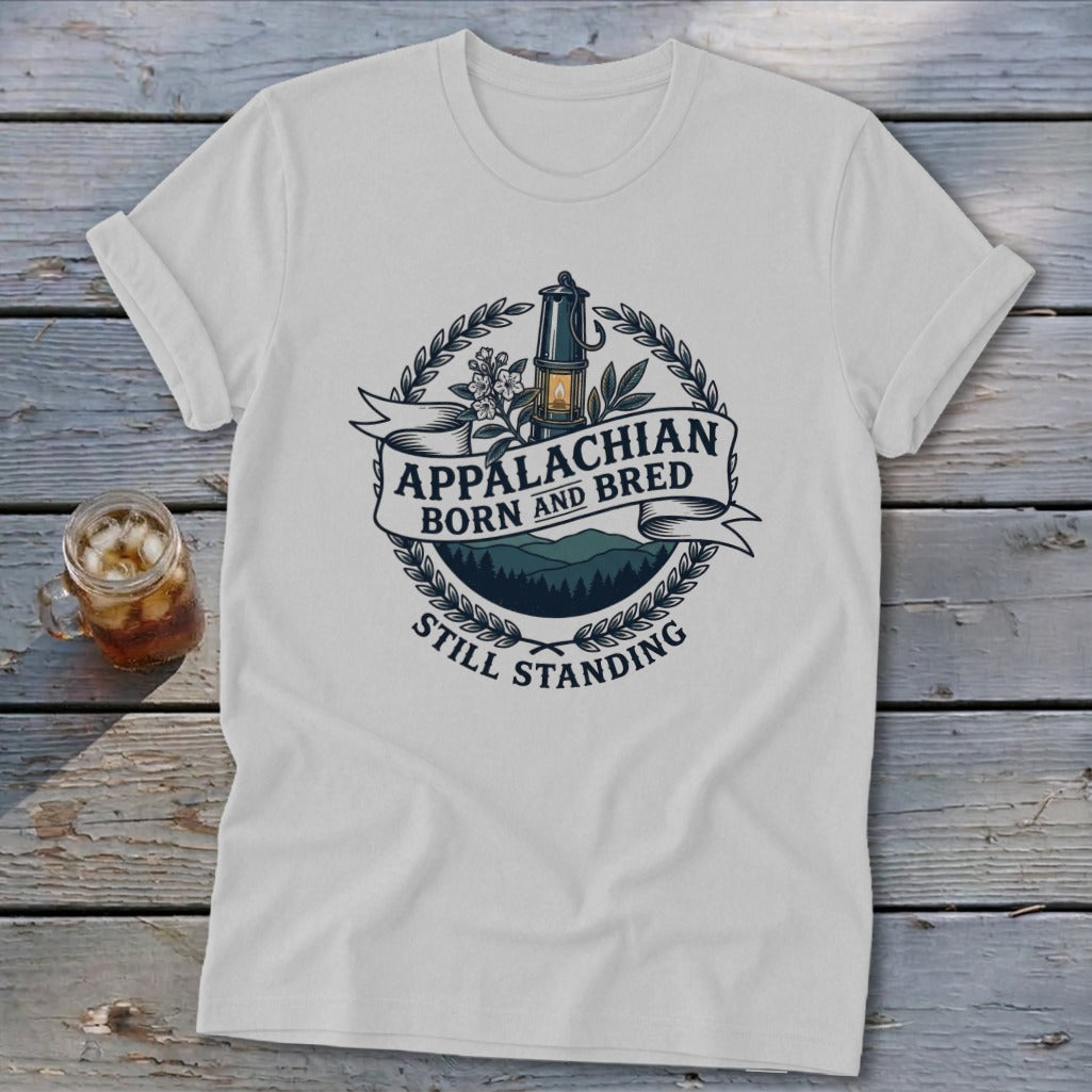 White t-shirt with Appalachian Born and Bred Still Standing emblem featuring a miner's lamp and mountains.